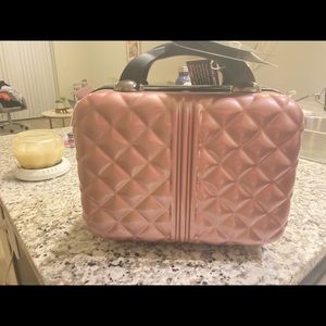 Light pink hard sided makeup travel case